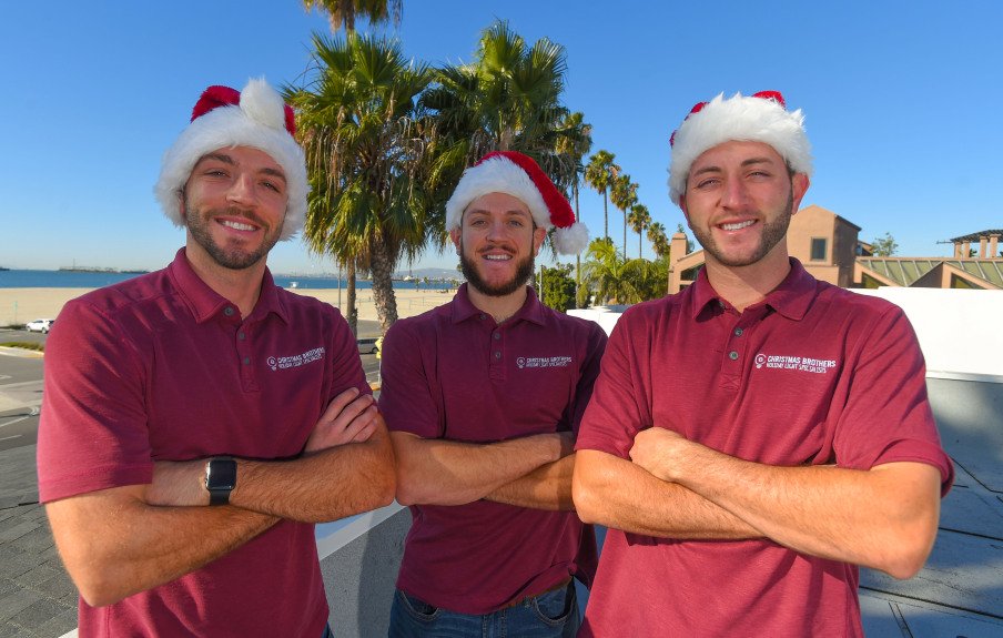 Christmas Brothers team wearing Santa hats and smiling are ready to help install holiday lighting for Hollywood homes