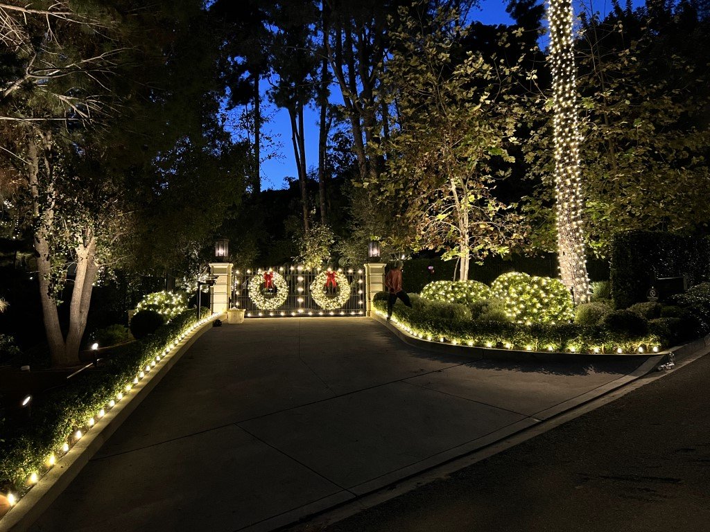 A Beverly Hills driveway and gates are decorated with holiday lighting and wreaths installed by Christmas Brothers professional Christmas light installers