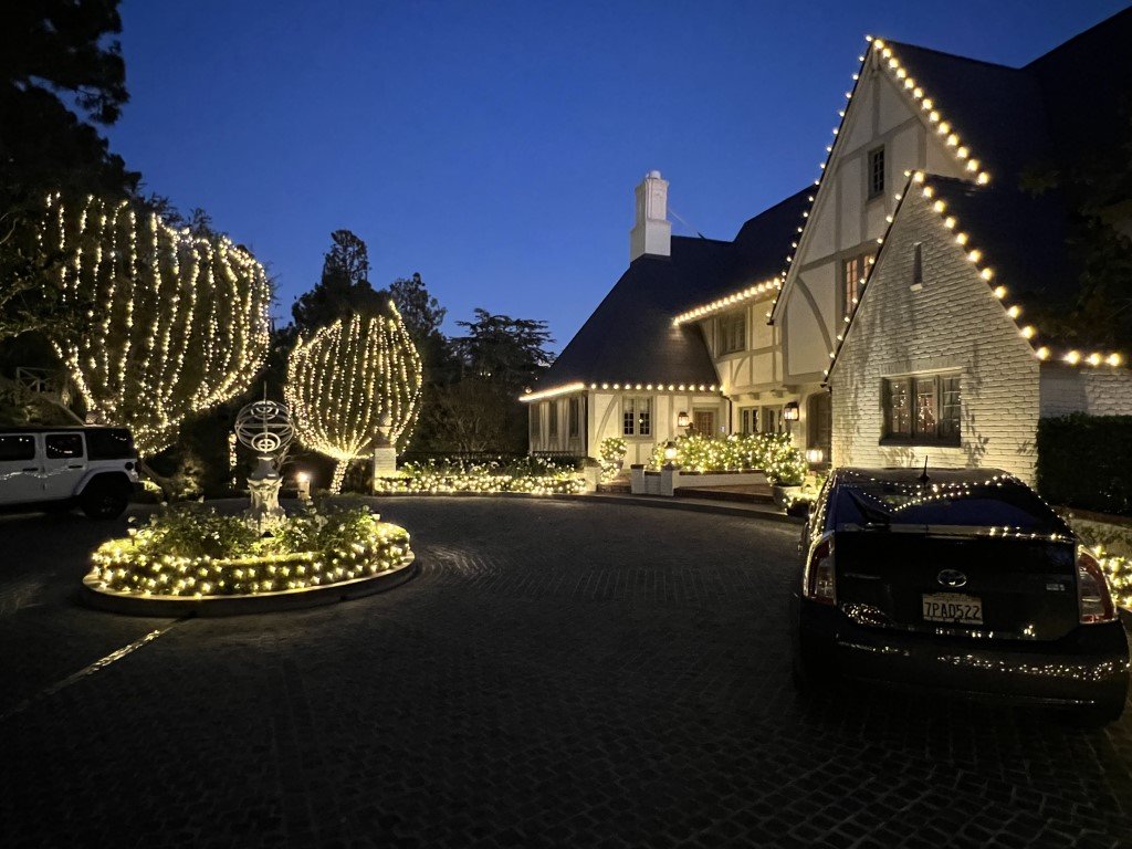 Christmas lighting decorates the rooflines, trees, and driveway by Christmas Brothers professional Christmas light installers